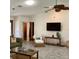 Comfortable living room with a mounted TV, wicker chair, and stylish decor at 1428 Pine Island Ct, Punta Gorda, FL 33950