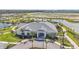 Aerial view of the community clubhouse, pool, tennis courts, and surrounding landscape, showcasing the community's amenities at 1524 Remington Trace Dr, Port Charlotte, FL 33953