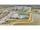 Beautiful aerial view of the community pool, tennis courts, and surrounding residential area, all within a well-maintained landscape at 1524 Remington Trace Dr, Port Charlotte, FL 33953