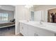 Bathroom featuring double sinks with views into the main bedroom with lake views at 1524 Remington Trace Dr, Port Charlotte, FL 33953