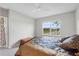 Bedroom with a ceiling fan, carpet floor, large window with blinds, and a bed with blue sheets at 1524 Remington Trace Dr, Port Charlotte, FL 33953