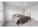 Bedroom with a large window, carpet floor, a ceiling fan, and access to a private bathroom at 1524 Remington Trace Dr, Port Charlotte, FL 33953