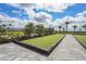 Community bocce ball court with well-maintained turf and paved walkway, providing a recreational space for residents at 1524 Remington Trace Dr, Port Charlotte, FL 33953