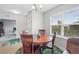 Inviting dining area featuring a round wooden table and large window at 1524 Remington Trace Dr, Port Charlotte, FL 33953