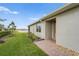 Exterior view of a home showcasing a manicured lawn and brick pathway at 1524 Remington Trace Dr, Port Charlotte, FL 33953