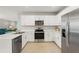 Bright kitchen featuring stainless steel appliances, quartz countertops, and ample cabinet space at 1524 Remington Trace Dr, Port Charlotte, FL 33953