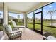 Screened in Lanai with patio furniture and views of a large yard at 1524 Remington Trace Dr, Port Charlotte, FL 33953