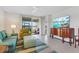 Bright living room with tile floors, access to the balcony, and comfortable seating arrangements at 1524 Remington Trace Dr, Port Charlotte, FL 33953