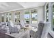 Relax in this stylish lounge with views of the pool, featuring comfortable seating and contemporary design at 1524 Remington Trace Dr, Port Charlotte, FL 33953