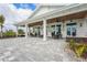 Inviting outdoor patio area with ample seating, ceiling fans, and beautiful landscaping, perfect for relaxing and entertaining at 1524 Remington Trace Dr, Port Charlotte, FL 33953