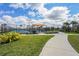 Community pickleball courts with a shaded picnic area, surrounded by lush landscaping and a walking path at 1524 Remington Trace Dr, Port Charlotte, FL 33953