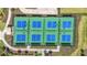 Aerial view of well-maintained tennis courts with green and blue surface, perfect for recreational games at 1524 Remington Trace Dr, Port Charlotte, FL 33953