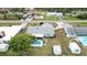 Aerial view showcasing a backyard pool, adjacent to a house with mature trees and ample yard space at 1582 Overbrook Rd, Englewood, FL 34223