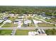Aerial view of homes, canal, and treeline with an asphalt street in view at 1582 Overbrook Rd, Englewood, FL 34223