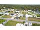 Overhead view of a neighborhood with a mix of homes, waterways, and plenty of trees at 1582 Overbrook Rd, Englewood, FL 34223