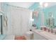 Bathroom with a sink, toilet, and shower/tub combo with a white shower curtain at 1582 Overbrook Rd, Englewood, FL 34223