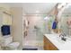 Clean and bright bathroom with a glass-enclosed shower and vanity with storage at 1582 Overbrook Rd, Englewood, FL 34223