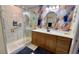 Bathroom featuring walk-in shower, wallpaper accent wall and vanity at 1582 Overbrook Rd, Englewood, FL 34223