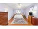Cozy bedroom with purple walls, wood floors, and ample natural light at 1582 Overbrook Rd, Englewood, FL 34223
