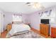 Calm bedroom with lavender walls, wood floors, and ample natural light at 1582 Overbrook Rd, Englewood, FL 34223