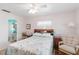 Bright bedroom with a comfortable bed, stylish seashell themed bedding, and a private bathroom entrance at 1582 Overbrook Rd, Englewood, FL 34223
