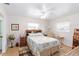 Comfortable bedroom with hardwood floors, ceiling fan, and ample natural light at 1582 Overbrook Rd, Englewood, FL 34223
