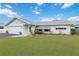 Well-maintained home with a lush green lawn, complemented by crisp, white trim and an attached garage at 1582 Overbrook Rd, Englewood, FL 34223