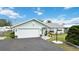 Well-kept house with manicured lawn and a convenient two-car garage with a paved driveway at 1582 Overbrook Rd, Englewood, FL 34223
