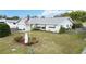 Charming single-story home features a well-manicured front lawn and an American flag at 1582 Overbrook Rd, Englewood, FL 34223