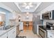 Open kitchen design with stainless appliances, granite counters, and view of the dining area at 1582 Overbrook Rd, Englewood, FL 34223