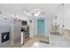 Well-lit kitchen with stainless steel appliances, granite countertops, and a ceiling fan with light at 1582 Overbrook Rd, Englewood, FL 34223