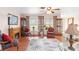 Cozy living room with hardwood floors, area rug, fireplace, and abundant natural light from the windows at 1582 Overbrook Rd, Englewood, FL 34223