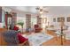 Spacious living room with hardwood floors, area rug, and floral curtains allowing natural light at 1582 Overbrook Rd, Englewood, FL 34223
