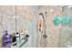Walk-in shower with tiled wall, brushed silver shower head, and a toiletry holder at 1582 Overbrook Rd, Englewood, FL 34223