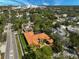 Aerial view of the home, showcasing the tile roof, turfed yard, and surrounding neighborhood at 1813 Boyce St, Sarasota, FL 34239