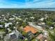 Aerial view of the home, showcasing the tile roof, pool, and lush neighborhood at 1813 Boyce St, Sarasota, FL 34239