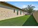 Backyard with artificial turf and a climbing wall. The house has many windows to let in light at 1813 Boyce St, Sarasota, FL 34239