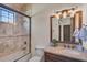 Bathroom showcasing marble countertops, shower with glass doors, vanity, and framed mirror at 1813 Boyce St, Sarasota, FL 34239