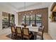 Bright dining room featuring a brick accent wall, a modern chandelier, and views of the outdoor pool area at 1813 Boyce St, Sarasota, FL 34239