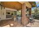 Inviting outdoor seating area featuring brick accents, a ceiling fan, and seamless access to indoor living space at 1813 Boyce St, Sarasota, FL 34239