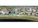 Beautiful aerial view of the home and surrounding community, complete with a pond and white picket fence at 1819 Redmond Brook Ln, Ruskin, FL 33570