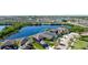 Aerial view of a home with a serene lake in the backyard and lush greenery surrounding the property at 1819 Redmond Brook Ln, Ruskin, FL 33570