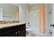 Bathroom featuring a double vanity, a combination tub and shower, and granite countertops at 1819 Redmond Brook Ln, Ruskin, FL 33570