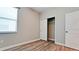 Comfortable bedroom with wood flooring, a window, and a sliding door closet at 1819 Redmond Brook Ln, Ruskin, FL 33570