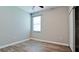 Bright bedroom with wood floors, neutral walls, a ceiling fan, and a view from a large window at 1819 Redmond Brook Ln, Ruskin, FL 33570