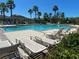 A community pool with lounge chairs and lush landscaping at 1819 Redmond Brook Ln, Ruskin, FL 33570