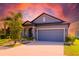 Charming single-Gathering home with blue siding, lush landscaping, and two-car garage at 1819 Redmond Brook Ln, Ruskin, FL 33570