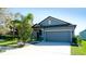 Charming single-Gathering home featuring a two-car garage, lush landscaping, and a well-maintained lawn at 1819 Redmond Brook Ln, Ruskin, FL 33570