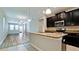 Modern kitchen with stainless steel appliances, dark cabinets and granite countertops at 1819 Redmond Brook Ln, Ruskin, FL 33570