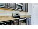 Modern kitchen featuring stainless steel oven and microwave appliances at 1819 Redmond Brook Ln, Ruskin, FL 33570